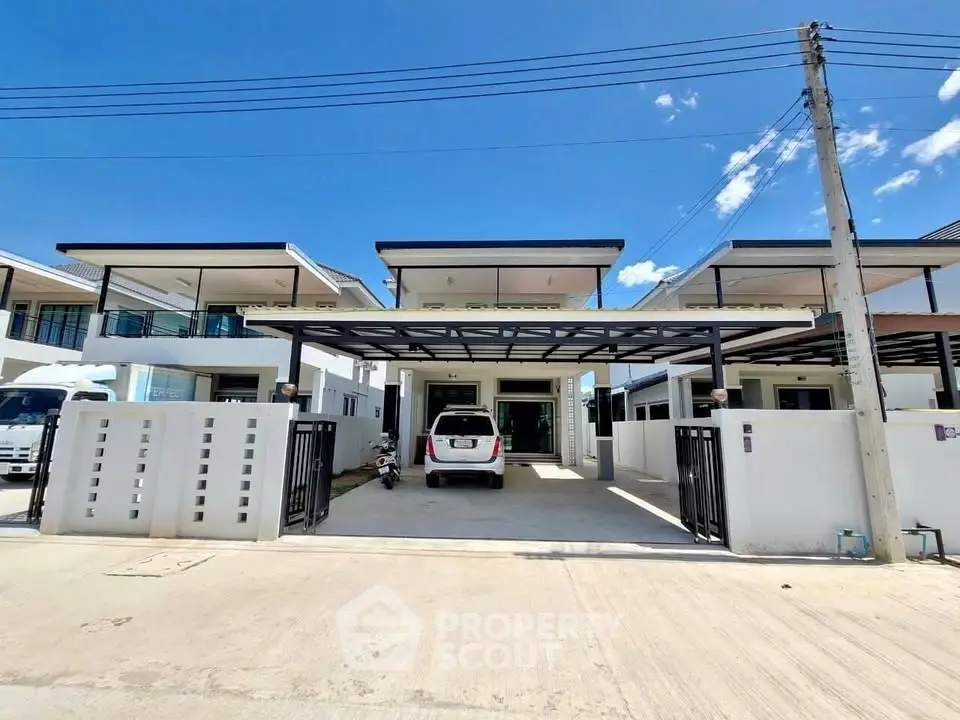 Modern residential property with spacious driveway and sleek design in a sunny neighborhood.