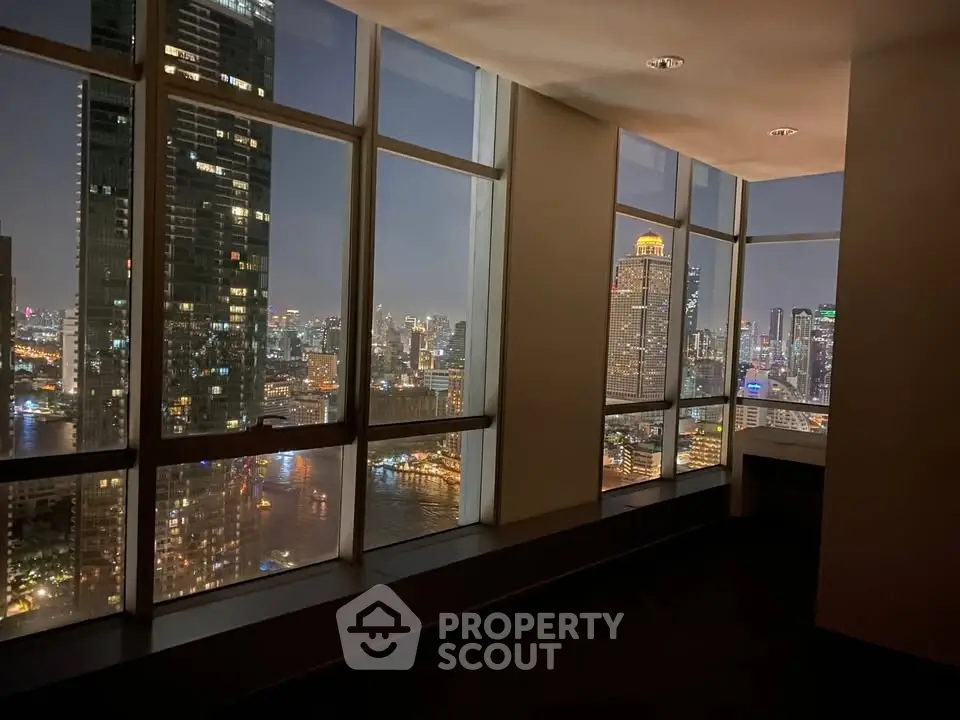 Stunning cityscape view from high-rise apartment window at night, showcasing vibrant urban skyline.