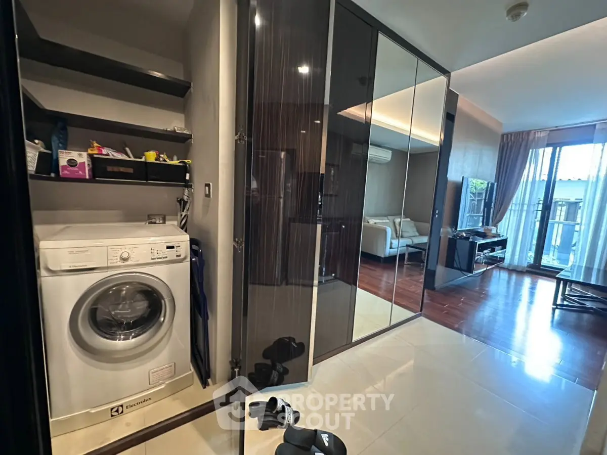 Modern apartment interior with washing machine and spacious living area