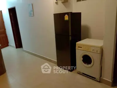 Spacious hallway with modern fridge and washing machine