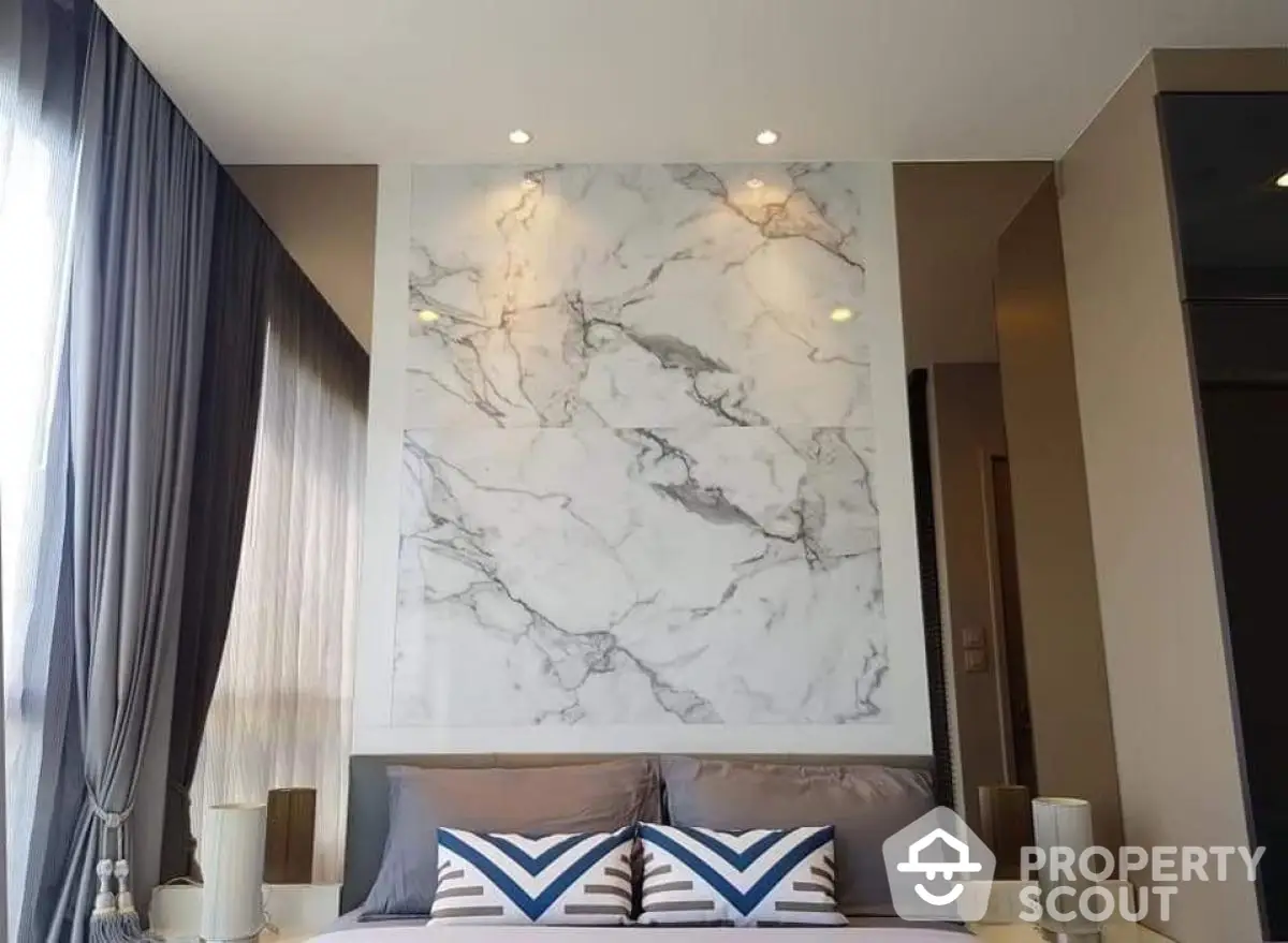 Luxurious bedroom with marble accent wall and elegant decor