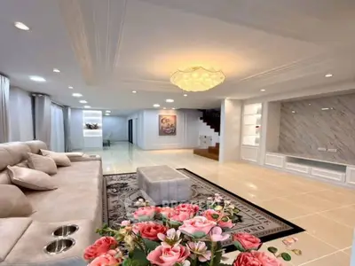 Luxurious living room with elegant chandelier and plush seating in modern home