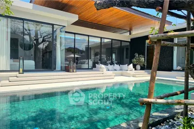 Luxurious modern villa with private pool and elegant outdoor seating area, perfect for relaxation.
