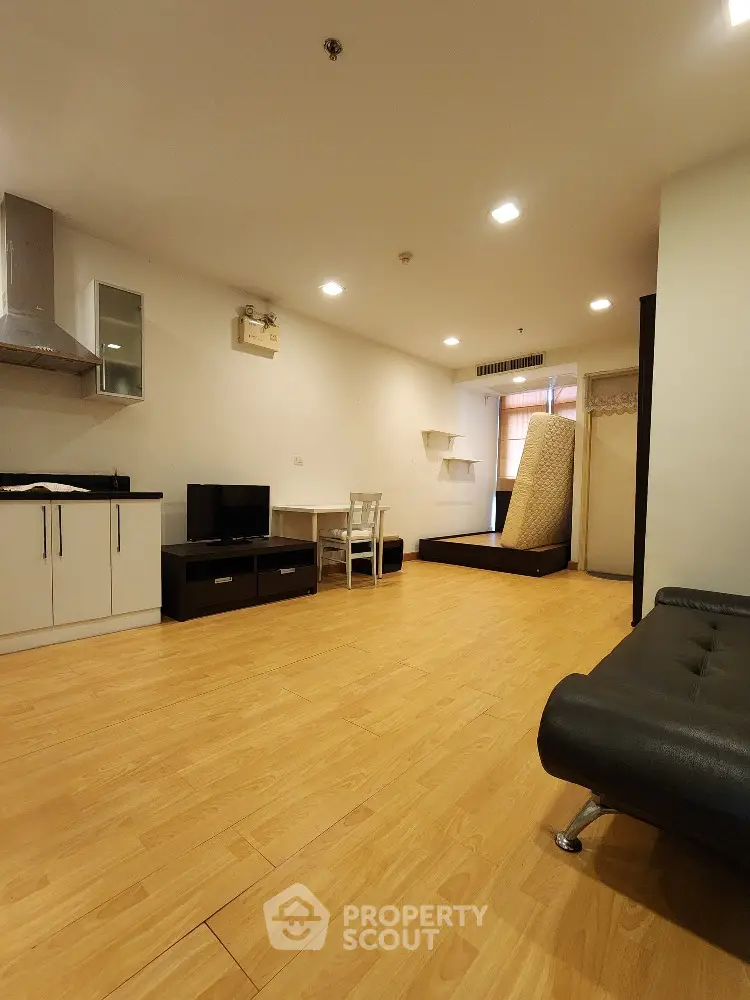 Spacious modern living room with wooden flooring and minimalist furniture
