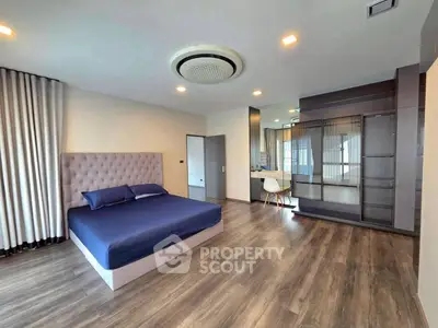 Spacious modern bedroom with elegant decor and ample natural light