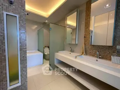 Luxurious modern bathroom with dual sinks and glass shower enclosure