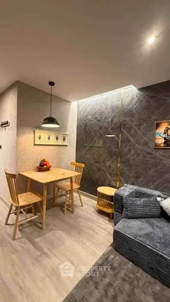 Stylish modern living room with cozy dining area and elegant lighting
