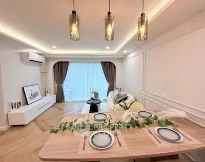 Elegant living room with modern dining setup and stylish lighting