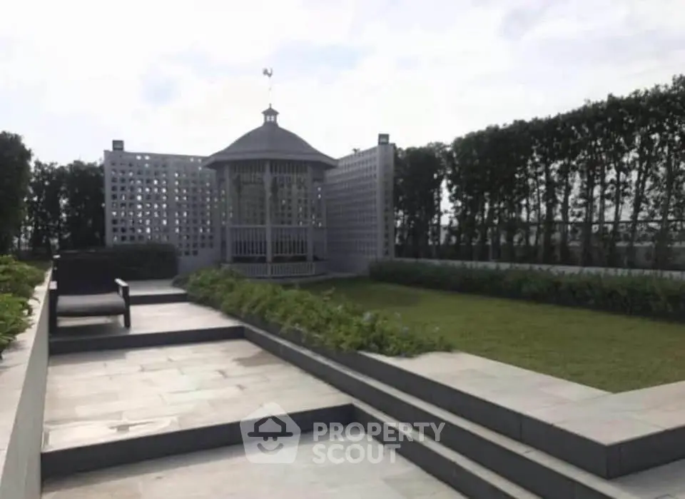 Elegant rooftop garden with gazebo and lush greenery, perfect for relaxation and gatherings.