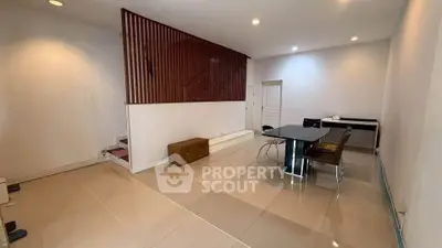Spacious modern living room with sleek tile flooring and stylish dining area.