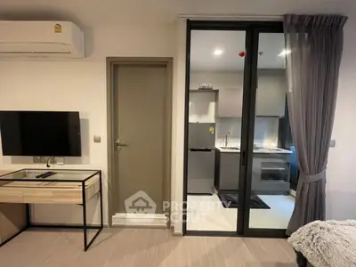 Modern studio apartment with sleek kitchen and stylish decor