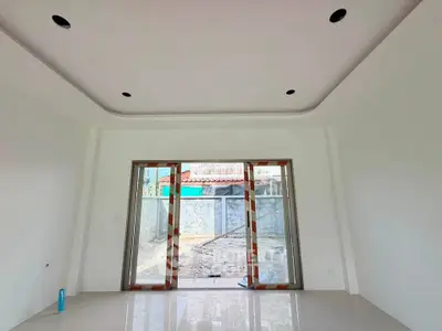 Spacious unfurnished room with large sliding glass doors leading to outdoor area, ideal for customization.