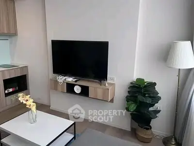 Modern living room with wall-mounted TV, stylish decor, and cozy ambiance.