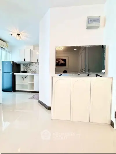 Modern living room with sleek TV stand and open kitchen layout