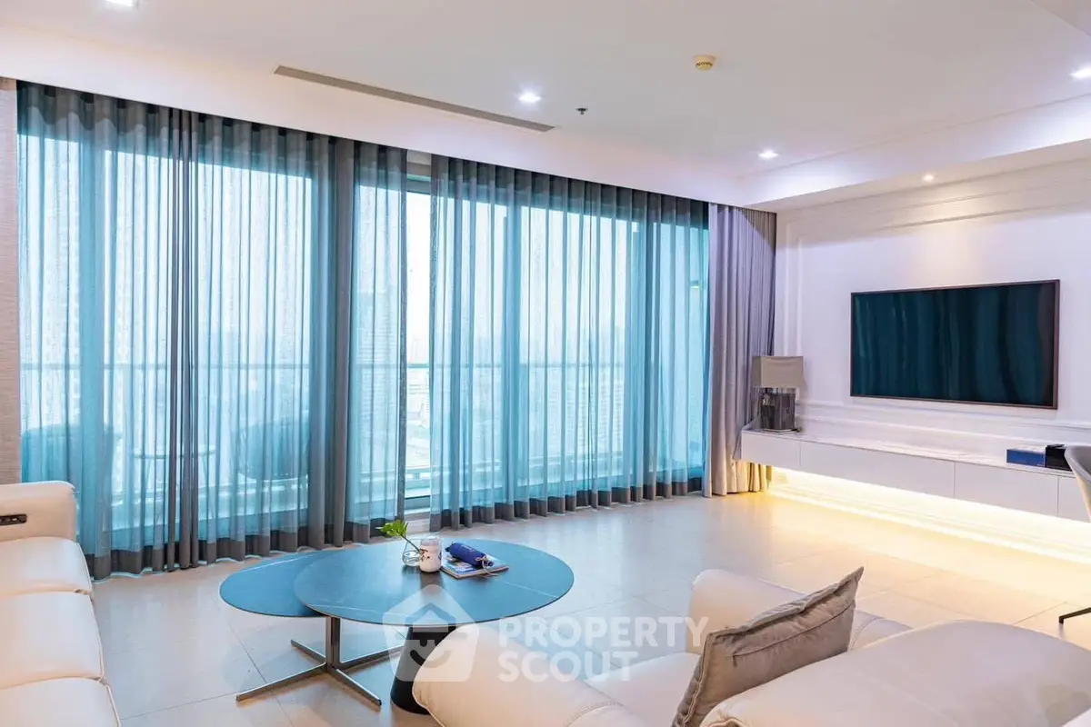 Spacious modern living room with large windows and elegant decor