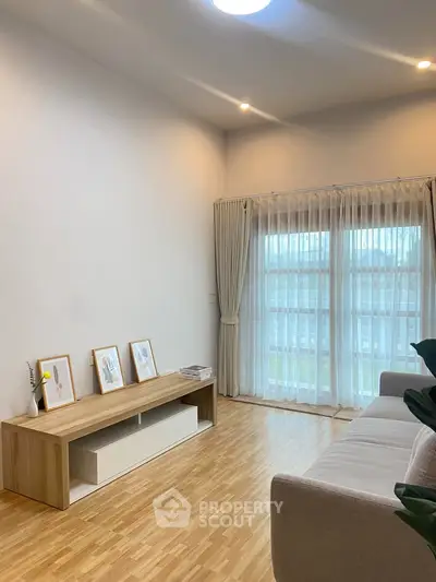 Bright and airy living room with large windows and modern decor