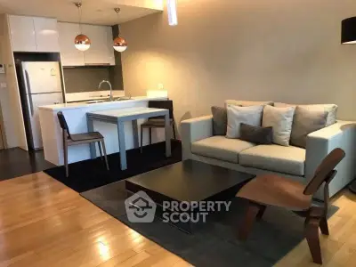Modern living room with open kitchen layout and stylish furniture