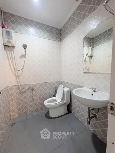 Modern bathroom with tiled walls, shower, and sleek fixtures