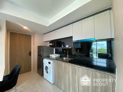 Modern kitchen with sleek cabinets and built-in appliances in a stylish apartment.