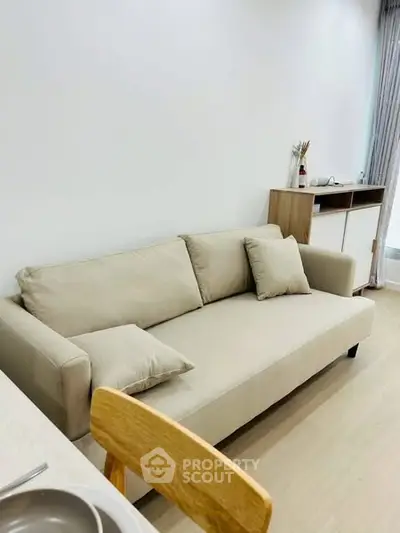 Modern living room with beige sofa and minimalist decor