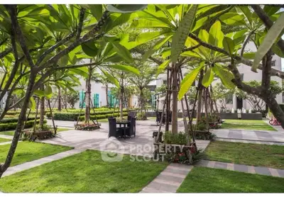 Lush garden area with seating in modern residential complex