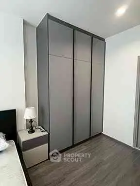 Modern bedroom with sleek wardrobe and stylish nightstand