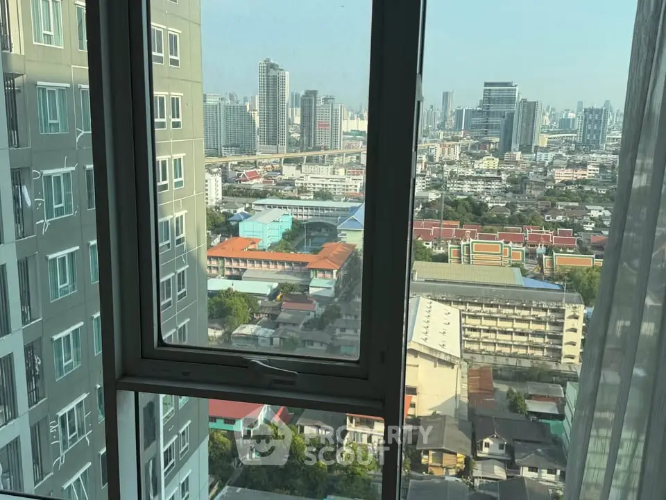 Stunning cityscape view from high-rise apartment window in urban setting.
