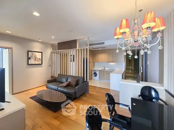 Luxurious open-plan living room with modern kitchen and elegant chandelier