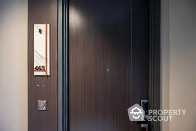 Modern apartment entrance with sleek wooden door and digital lock