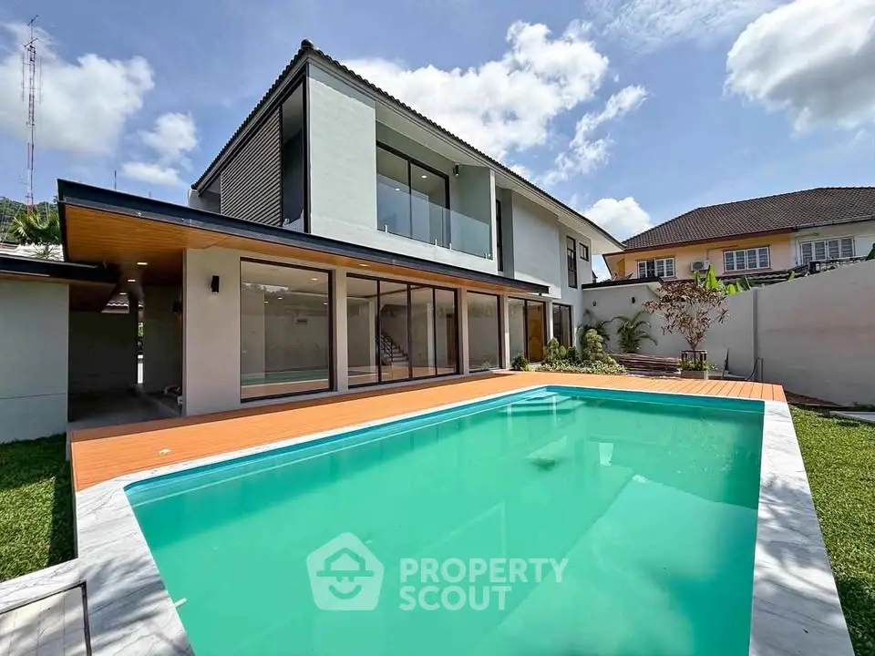 Luxurious modern home with a stunning pool and spacious backyard, perfect for relaxation and entertainment.