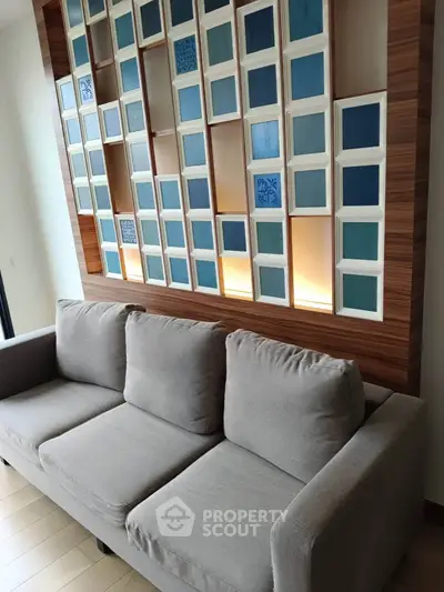Modern living room with stylish sofa and decorative wall paneling