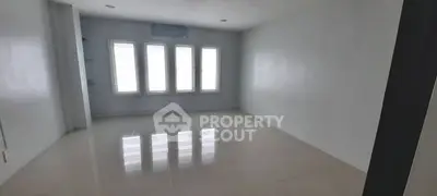 Spacious empty room with large windows and glossy floor tiles