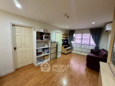 Spacious living room with wooden flooring and modern furnishings