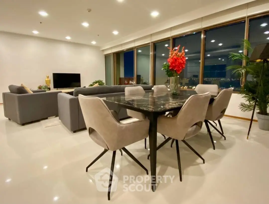 Luxurious open-plan living and dining area with modern furniture and panoramic city views.