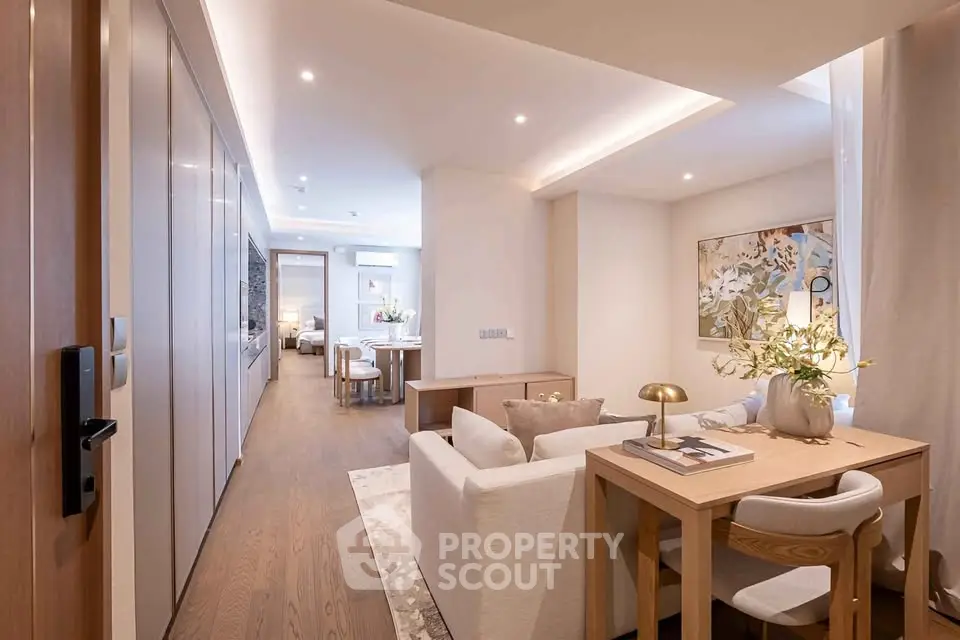Luxurious open-plan living room with elegant decor and cozy seating area, perfect for modern living.