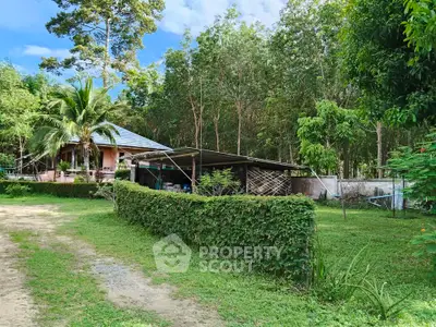 Charming rural property with lush greenery and cozy house, perfect for nature lovers seeking tranquility.