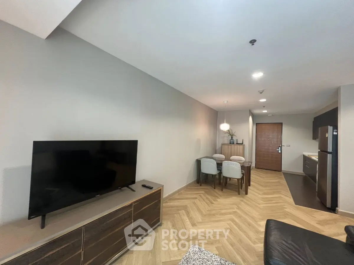 Modern living room with sleek furniture and open kitchen layout