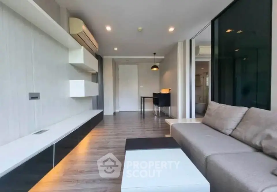 Modern living room with sleek design and air conditioning in a stylish apartment.
