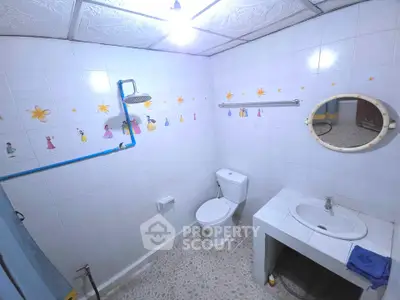 Charming bathroom with unique wall decor and modern fixtures.