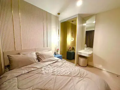 Modern bedroom with stylish decor and cozy ambiance, featuring elegant lighting and a comfortable bed.