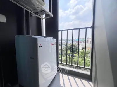 Modern balcony with washing machine and scenic view, perfect for urban living.