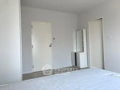 Minimalist bedroom with white walls and modern furniture