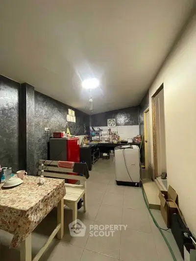 Spacious kitchen with modern appliances and dining area, featuring a closed layout and stylish decor.
