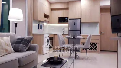 Modern open-plan kitchen and living area with sleek appliances and stylish decor.
