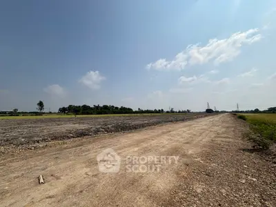 Expansive land plot with clear skies, ideal for development opportunities.