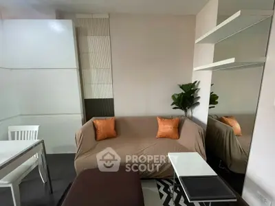 Cozy living room with modern decor and comfortable seating in a stylish apartment.