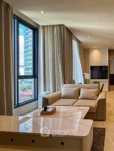 Luxurious modern living room with large windows and elegant furnishings