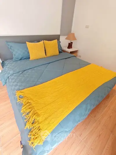 Cozy bedroom with stylish bedding and warm lighting, perfect for relaxation.