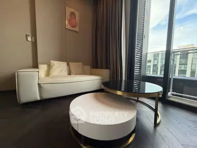 Modern living room with sleek furniture and large window view