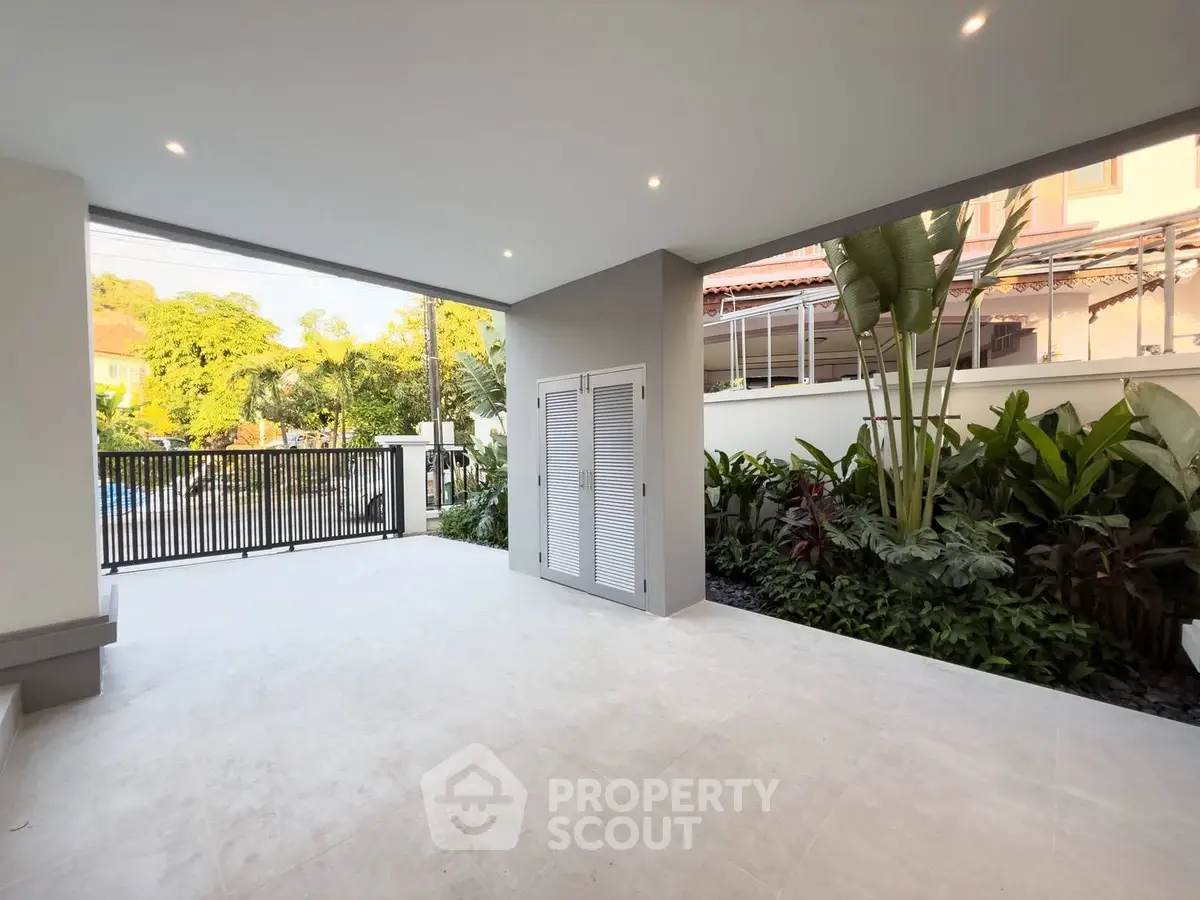 Spacious covered patio with lush garden view in modern home